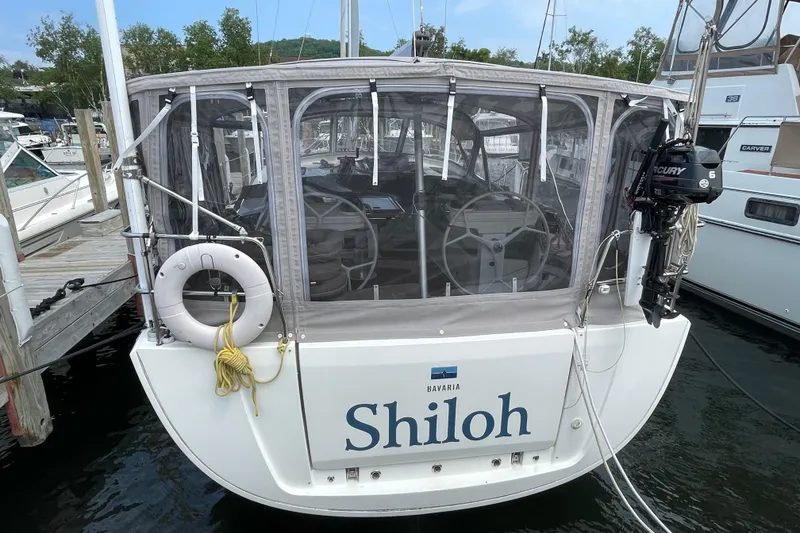 Slide: The Image of 2013 Bavaria Vision 42 sailboat "Shiloh" docked, featuring enclosed cockpit and outboard motor. - 3