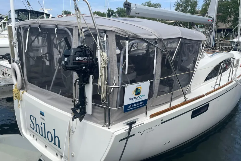 Slide: The Image of 2013 Bavaria Vision 42 yacht docked with protective canopy and outboard motor. - 4