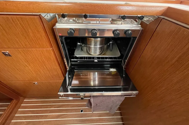 Slide: The Image of Bavaria Vision 42 yacht kitchen with open oven, showcasing wooden cabinetry, 2013 model. - 47