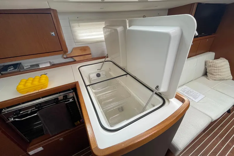Slide: The Image of Interior of 2013 Bavaria Vision 42 yacht with open fridge, oven, and seating area. - 48
