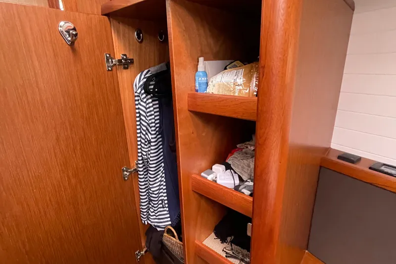 Slide: The Image of Wooden closet interior on 2013 Bavaria Vision 42 yacht, with clothes and shelves. - 67