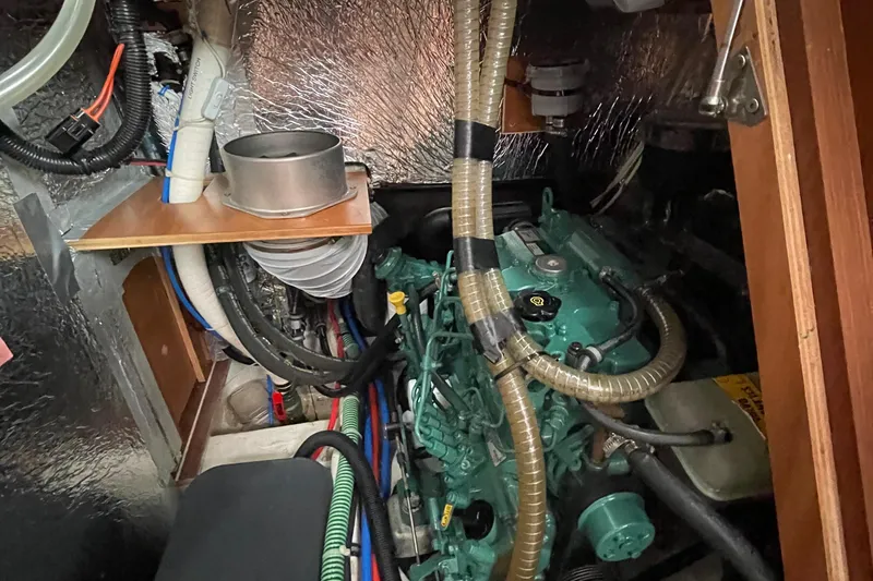 Slide: The Image of Engine compartment of a 2013 Bavaria Vision 42 sailboat, showcasing mechanical components and wiring. - 69
