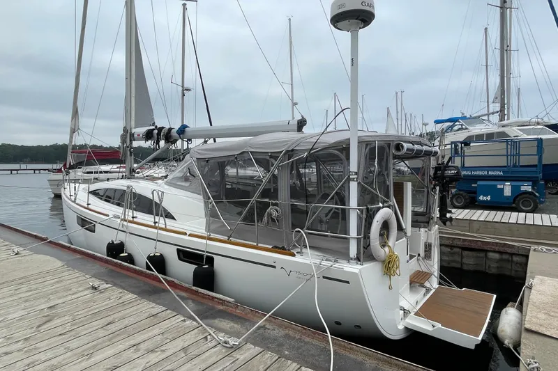 Slide: The Image of 2013 Bavaria Vision 42 sailboat docked at marina, featuring sleek design and covered cockpit. - 7