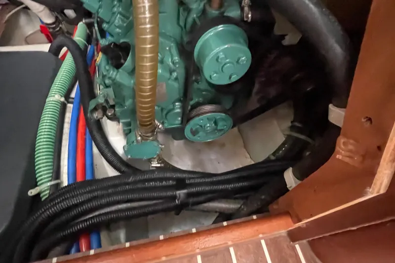 Slide: The Image of Engine compartment of a 2013 Bavaria Vision 42 sailboat with visible hoses and components. - 71