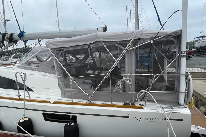 Slide: The Image of Sailboat Bavaria Vision 42, 2013 model, docked with protective canopy and visible rigging. - 9