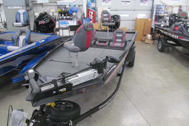 Slide: The Image of 2026 Ranger RT198P fishing boat in showroom, featuring modern seating and equipment. - 2