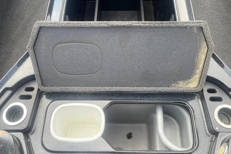 Slide: The Image of 2021 Nitro Z20 boat storage compartment with open lid and cup holders. - 10