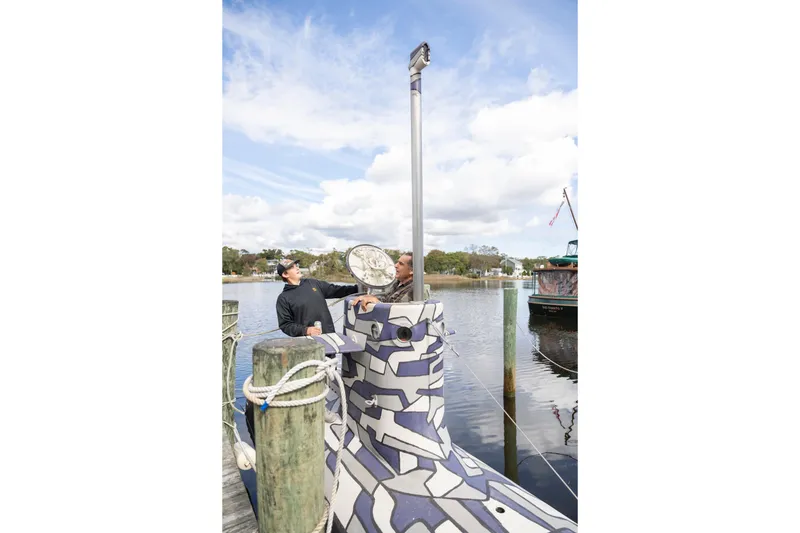 Slide: The Image of 2023 Submarine 28 Composite Construction docked, featuring unique camouflage design and periscope. - 11