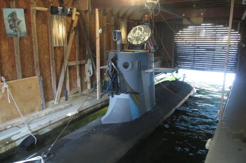 Slide: The Image of 2023 Submarine 28 Composite Construction docked in a wooden boathouse. - 4