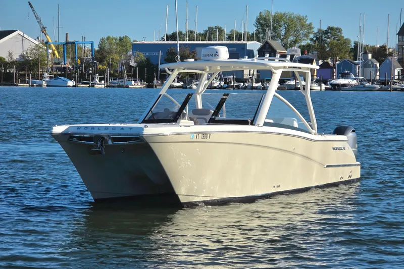 The Image of 2018 World Cat 280 DC-X boat on calm water near marina. - 0