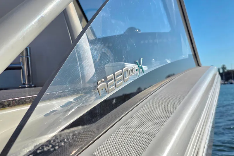 Slide: The Image of Close-up of 2018 World Cat 280 DC-X boat logo with water in background. - 14