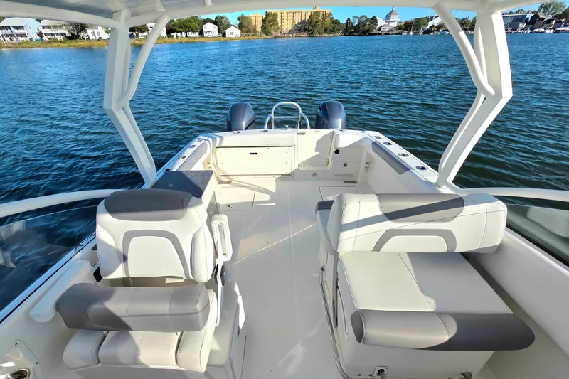 Slide: The Image of 2018 World Cat 280 DC-X boat interior with seating, on calm water. - 16
