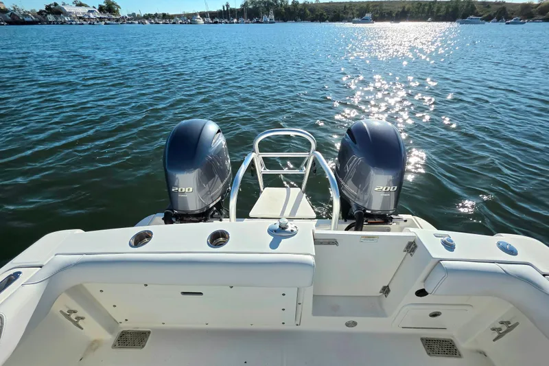 Slide: The Image of 2018 World Cat 280 DC-X boat with twin 200 horsepower engines on a sunny lake. - 18