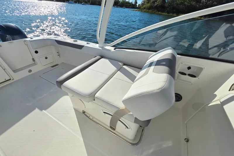 Slide: The Image of 2018 World Cat 280 DC-X boat interior with white seating and scenic water view. - 19
