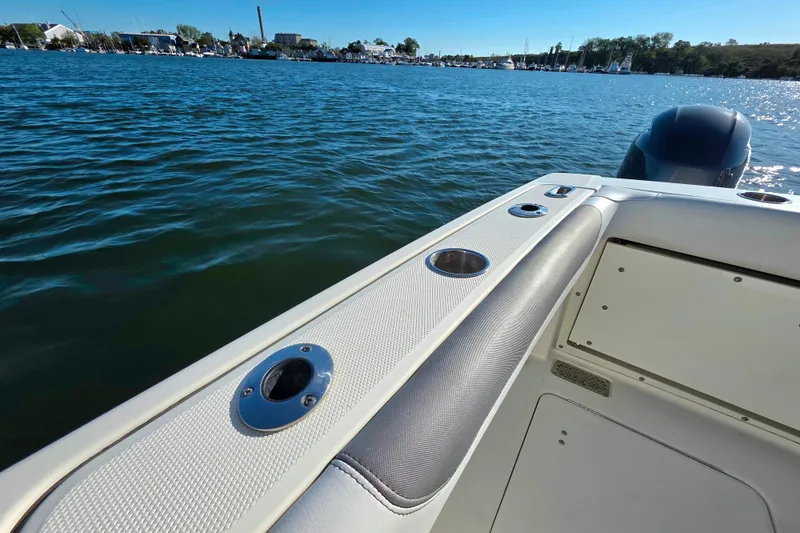 Slide: The Image of 2018 World Cat 280 DC-X boat on calm water, featuring sleek design and cup holders. - 20