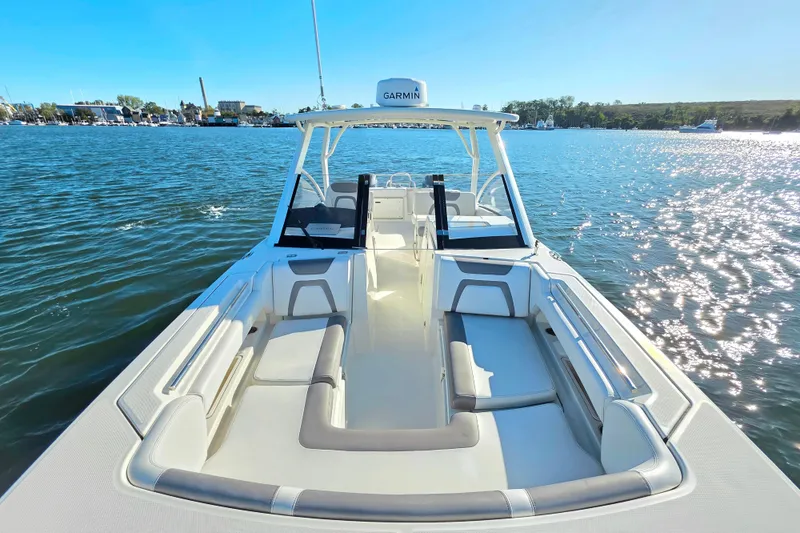 Slide: The Image of 2018 World Cat 280 DC-X boat on water, featuring spacious seating and Garmin equipment. - 28