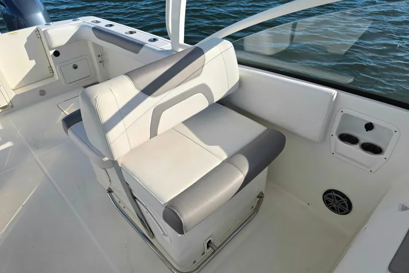 Slide: The Image of 2018 World Cat 280 DC-X boat interior with cushioned seating and cup holders. - 31