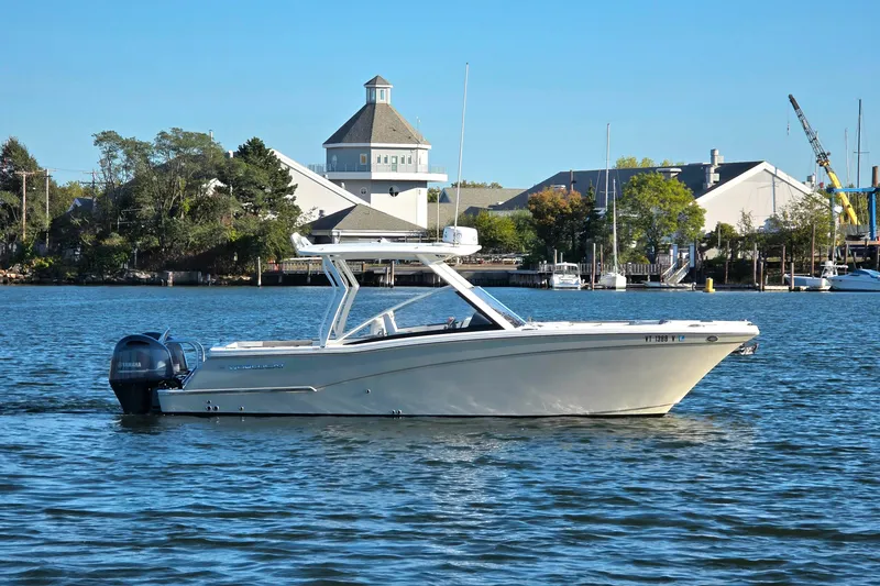 Slide: The Image of 2018 World Cat 280 DC-X boat on calm water near marina. - 34