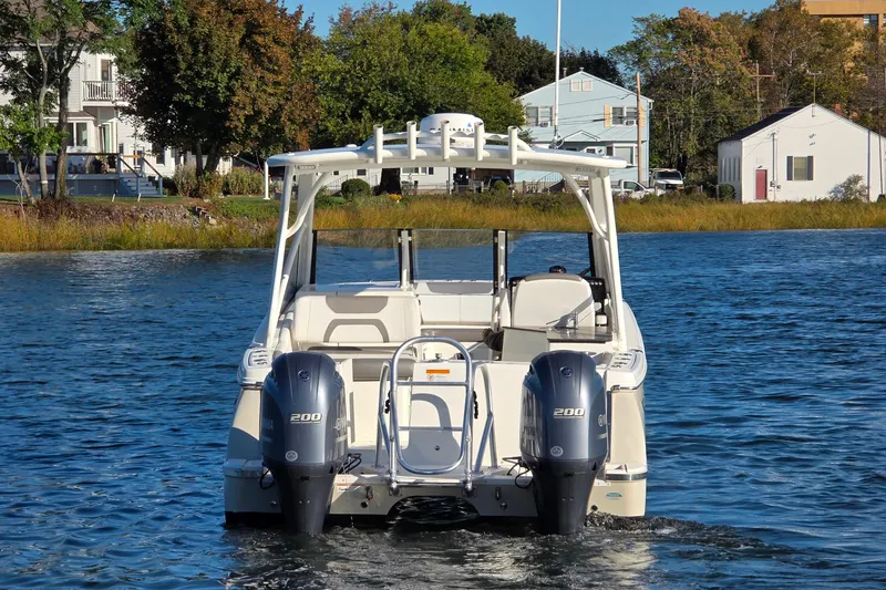 Slide: The Image of 2018 World Cat 280 DC-X boat on water, dual engines, scenic background. - 6