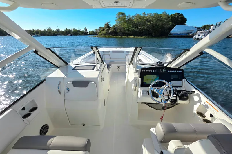 Slide: The Image of 2018 World Cat 280 DC-X boat interior with steering wheel and navigation system. - 7