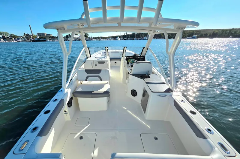 Slide: The Image of 2018 World Cat 280 DC-X boat on water, spacious deck, sunny day. - 8