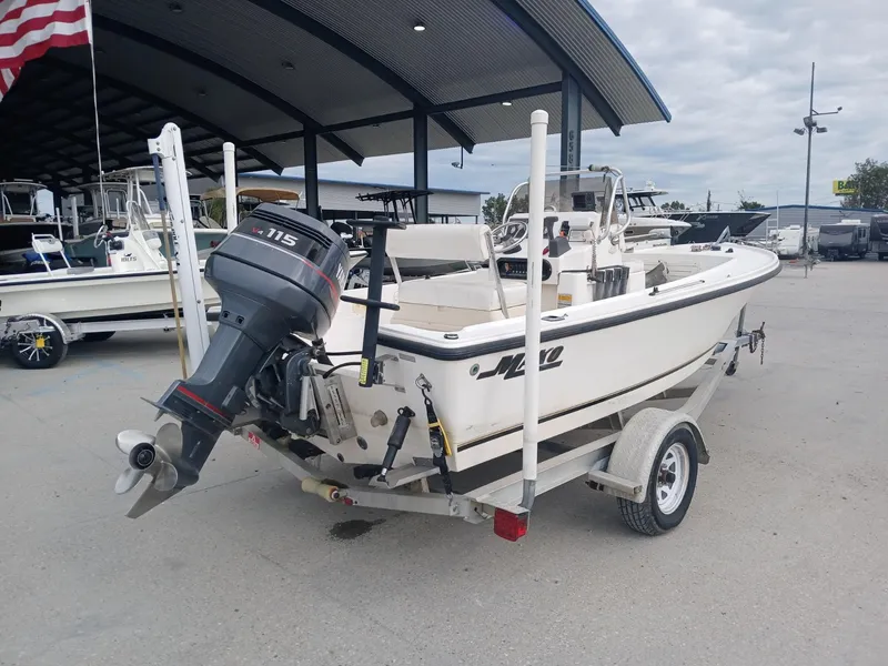 Slide: The Image of 2001 Mako 171 boat on trailer with outboard motor, parked in marina. - 11