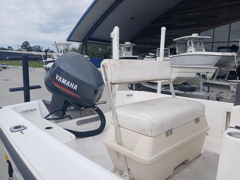 Slide: The Image of 2001 Mako 171 boat with Yamaha outboard motor, parked at a marina. - 2