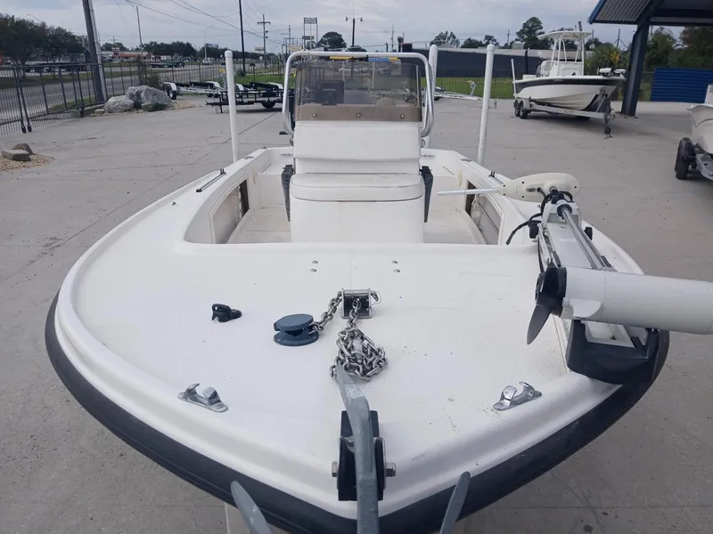 Slide: The Image of 2001 Mako 171 boat, white, docked outdoors, featuring anchor and motor. - 7