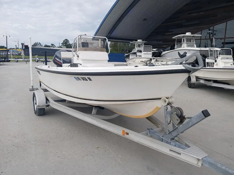 Slide: The Image of 2001 Mako 171 boat on trailer, parked outdoors near other boats. - 8