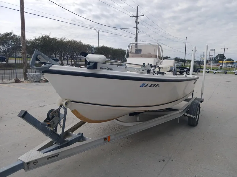 Slide: The Image of 2001 Mako 171 boat on trailer, parked outdoors under cloudy sky. - 9