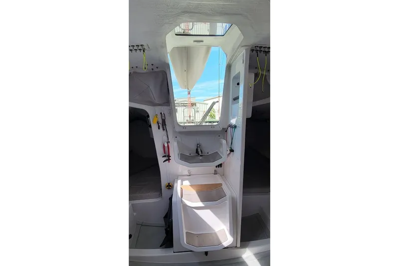 Slide: The Image of Interior of 2020 Dehler 30 OD sailboat, featuring compact cabin design and skylight. - 14