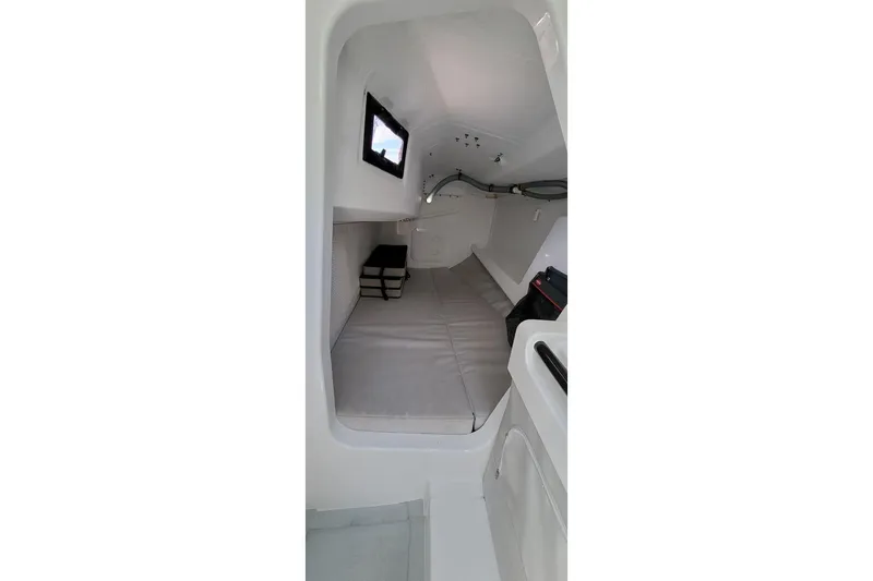 Slide: The Image of Interior cabin of 2020 Dehler 30 OD sailboat, featuring minimalist design and compact sleeping area. - 16