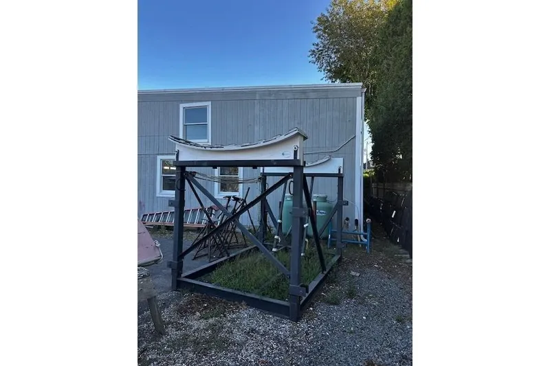 Slide: The Image of Outdoor storage of Dehler 30 OD boat hull, 2020 model, near a wooden building. - 27