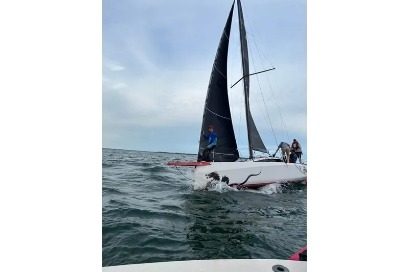 Slide: The Image of 2020 Dehler 30 OD sailboat navigating open waters with crew onboard. - 28