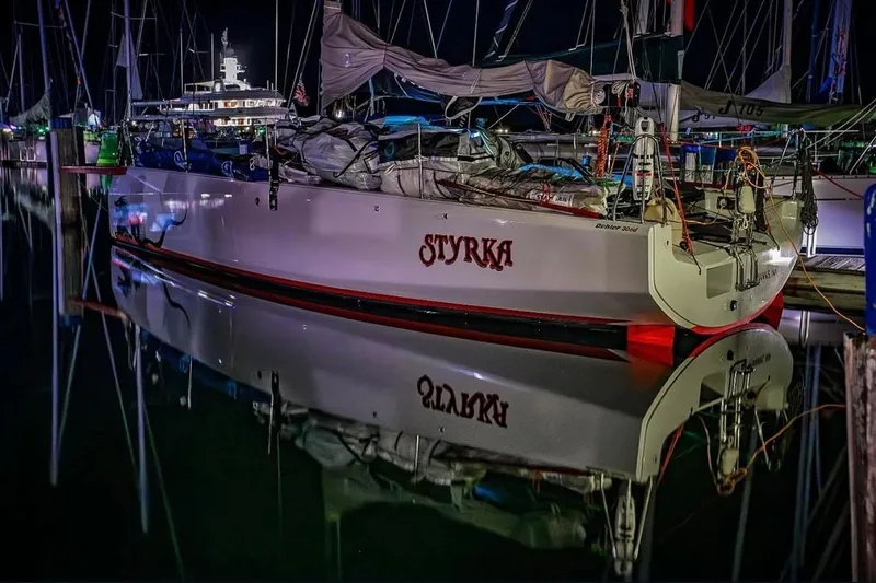 Slide: The Image of 2020 Dehler 30 OD sailboat "Styrka" docked at night, reflecting on calm water. - 3