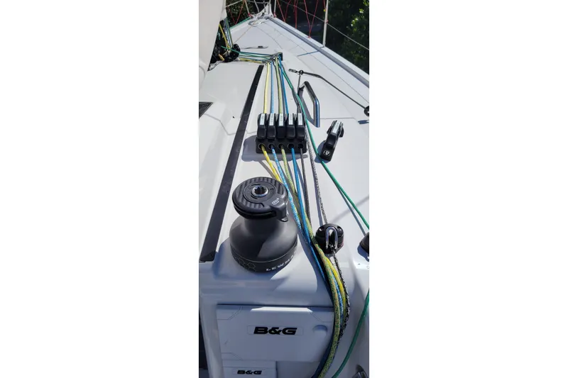 Slide: The Image of Dehler 30 OD 2020 sailboat deck with winch and colorful ropes. - 7