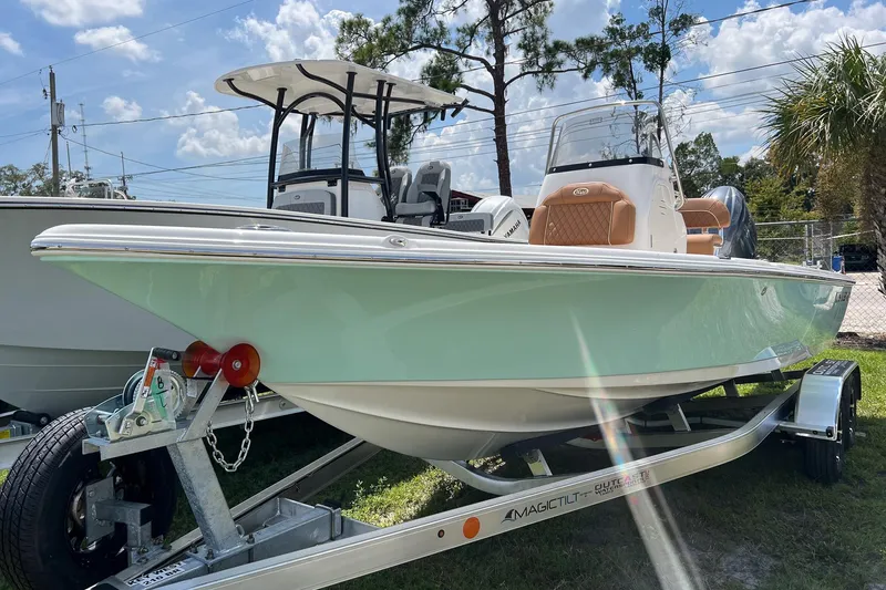 The Image of 2026 Key West 210 Bay Reef boat on trailer, displayed outdoors under a sunny sky. - 0
