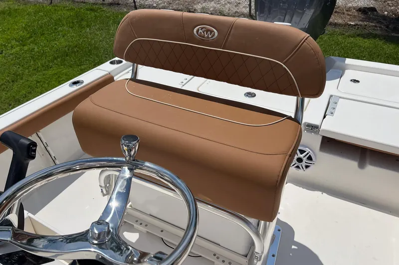 Slide: The Image of 2026 Key West 210 Bay Reef boat seat with tan upholstery and steering wheel. - 14