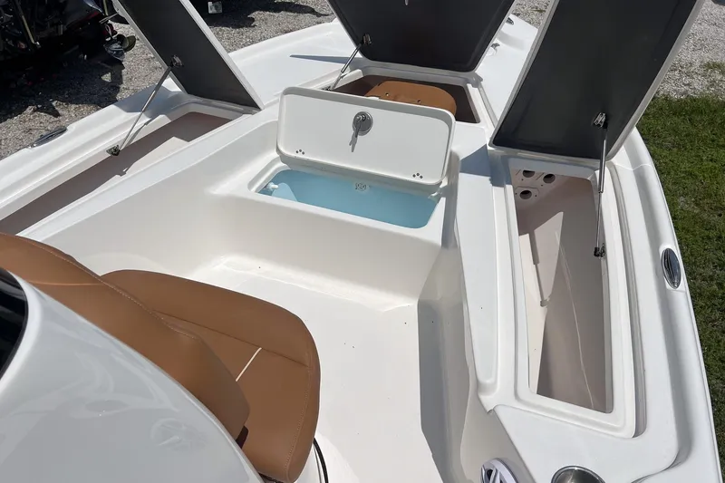 Slide: The Image of 2026 Key West 210 Bay Reef boat interior with open storage compartments and seating. - 17