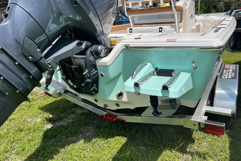 Slide: The Image of 2026 Key West 210 Bay Reef boat on trailer, featuring outboard motor and teal hull. - 5