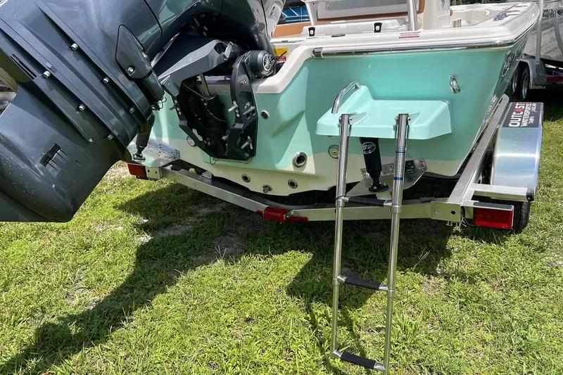 Slide: The Image of 2026 Key West 210 Bay Reef boat on trailer, featuring outboard motor and ladder. - 6