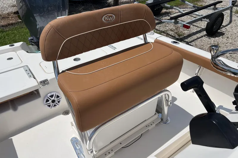 Slide: The Image of 2026 Key West 210 Bay Reef boat with tan seating and steering console. - 9