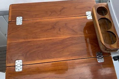 Slide: The Image of 1995 Little Harbor 51 Pilothouse interior with striped seating and wooden paneling. - 10