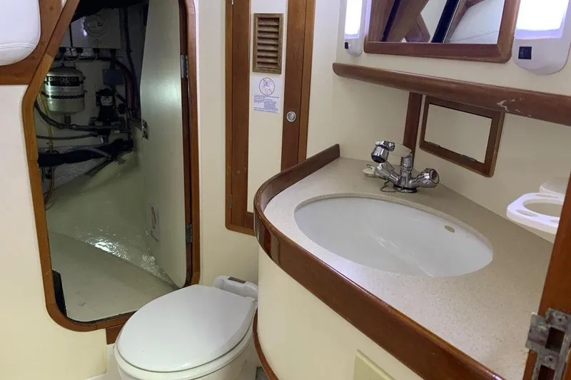 Slide: The Image of Polished wooden surface with hinges on a 1999 Little Harbor 51 Pilothouse yacht. - 14