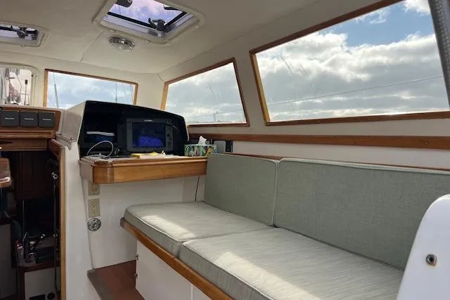 Slide: The Image of Interior of 1995 Little Harbor 51 Pilothouse yacht with navigation equipment and seating area. - 21