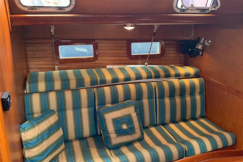 Slide: The Image of 1999 Little Harbor 51 Pilothouse interior with cozy seating and wooden table. - 7