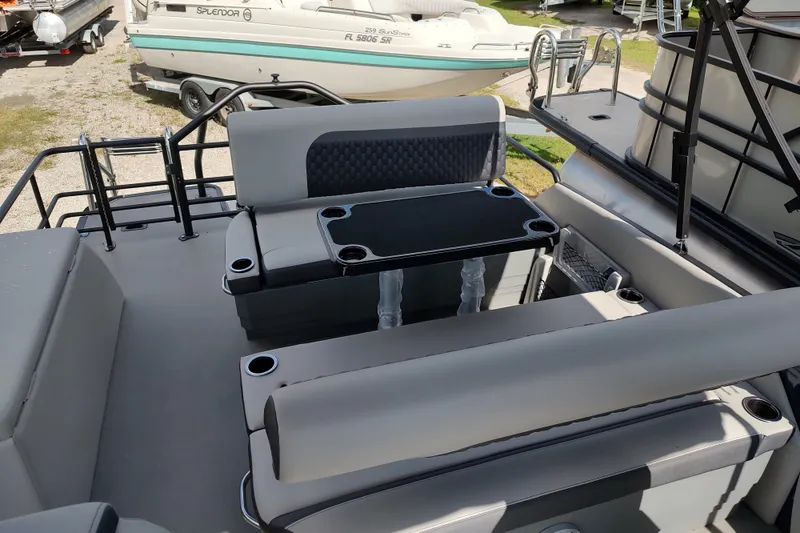 Slide: The Image of 2026 Sylvan L3 DLZ pontoon boat interior with seating and table, featuring cup holders. - 13