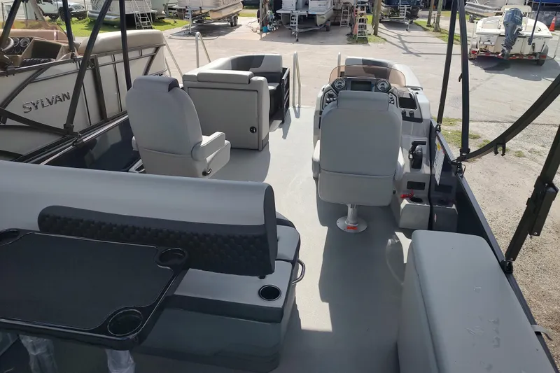 Slide: The Image of 2026 Sylvan L3 DLZ pontoon boat interior with seating and helm station. - 14