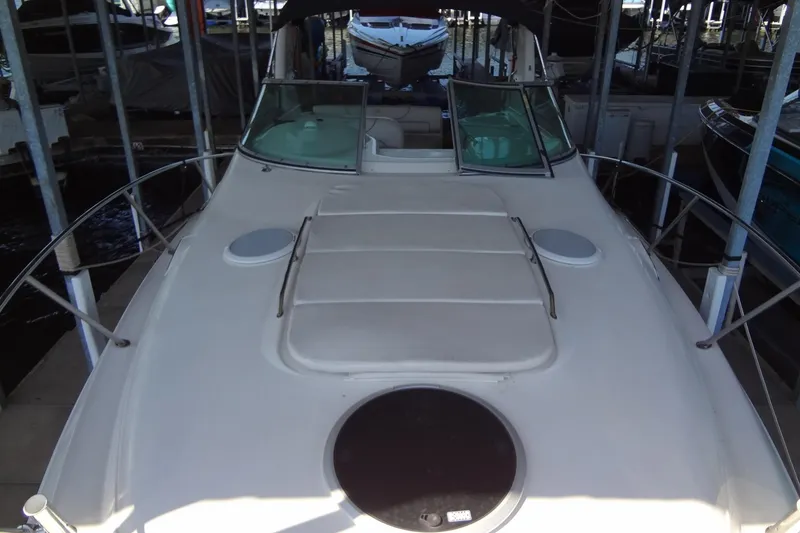 Slide: The Image of 2000 Monterey 302 Cruiser boat docked in a marina, viewed from the bow. - 13