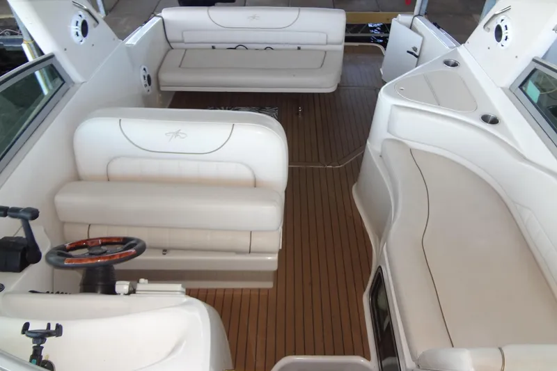 Slide: The Image of Interior of a 2000 Monterey 302 Cruiser with white seating and wooden flooring. - 14